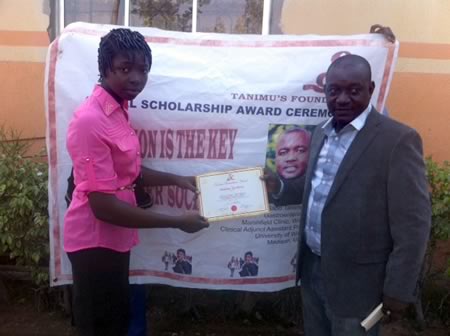 The overall best student of 2014 from ECWA Secondary School receiving the Tanimu foundation scholarship Award.